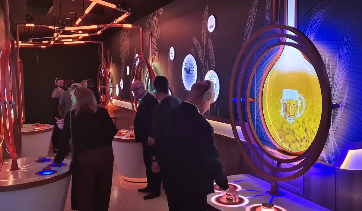 Visitors exploring the Hypsos experience center for Pilsner Urquell