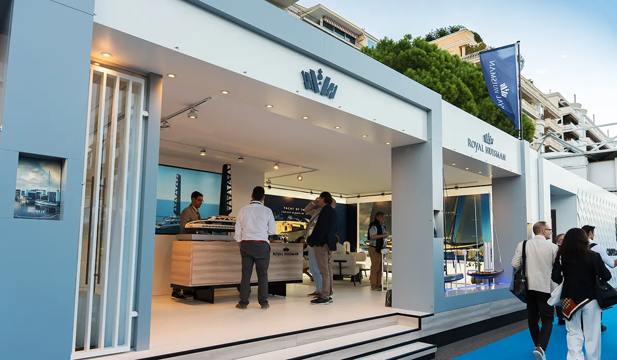 Visitors exploring the Hypsos exhibition stand for Royal Huisman at the Monaco Yacht Show 2025
